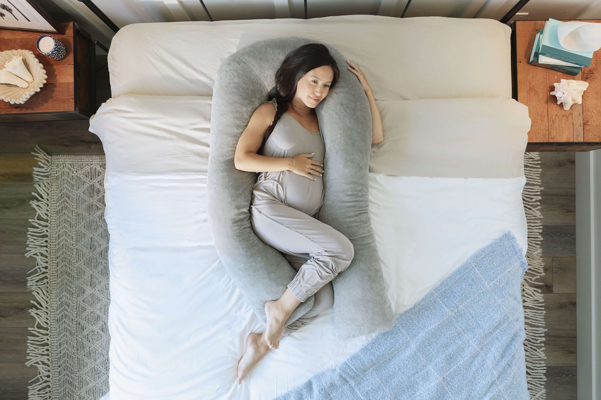 Pregnant woman using a Pregnancy Body Pillow in bed