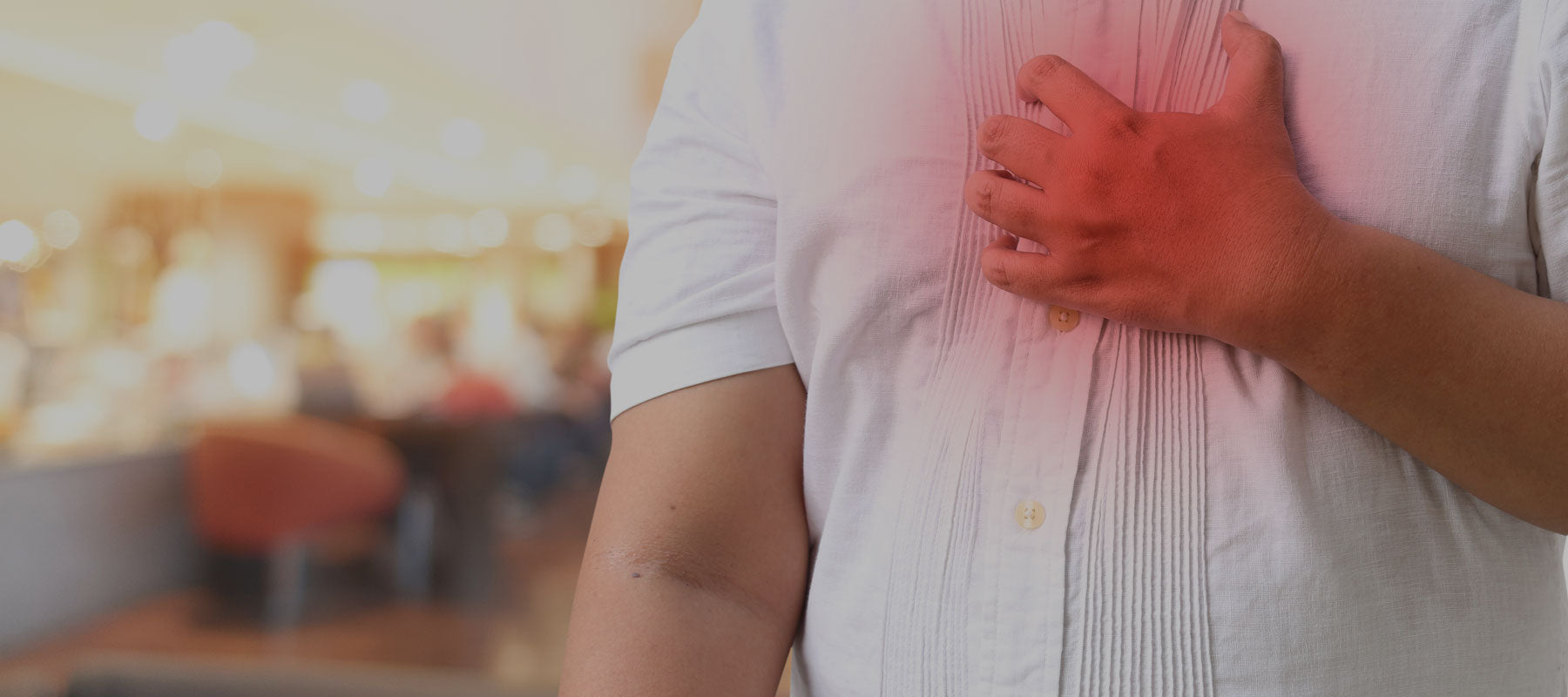 man holding chest from acid reflux