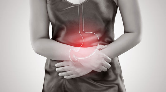 woman with acid reflux holding stomach