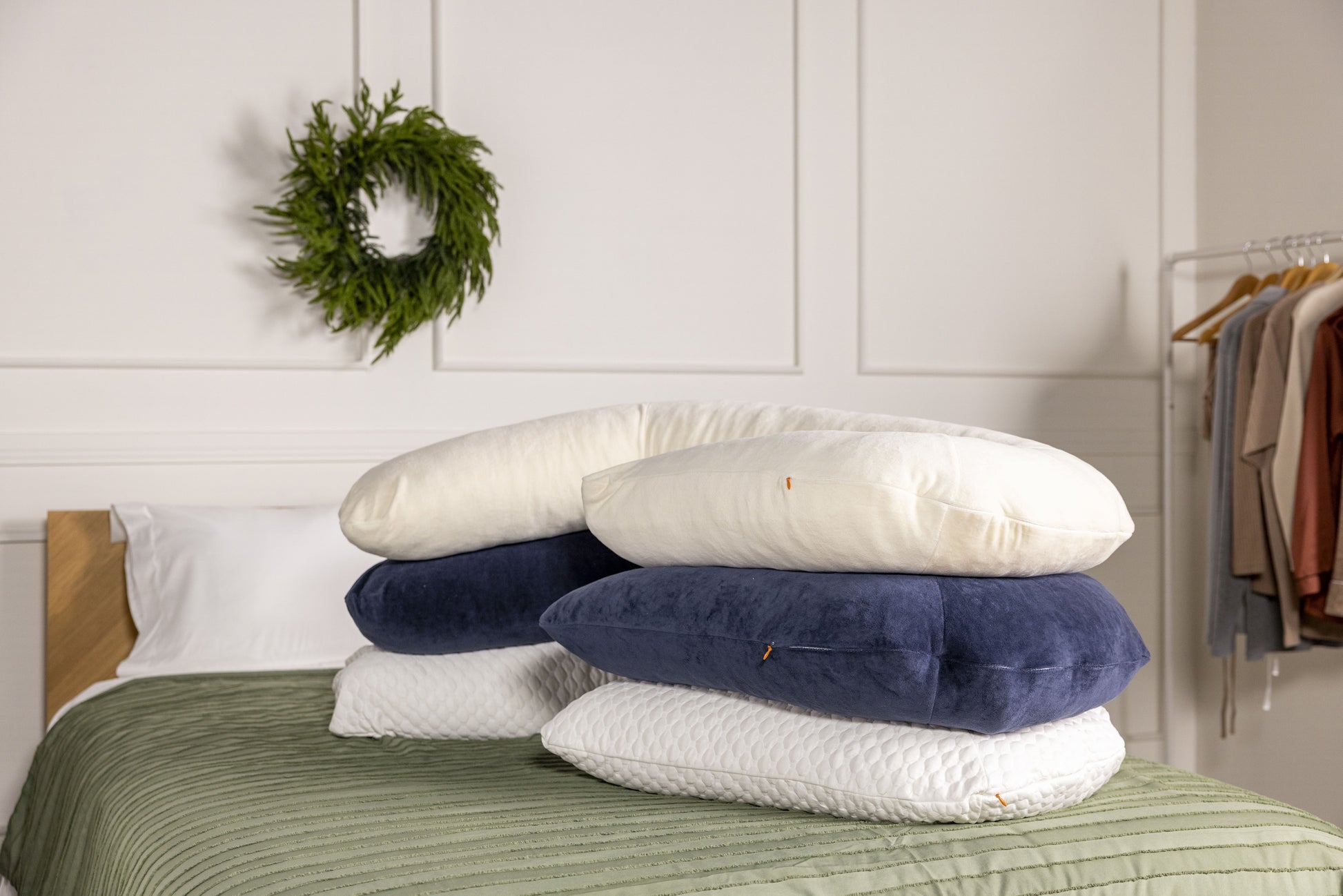 Stack of body pillows with war ivory, midnight navy and cooling case