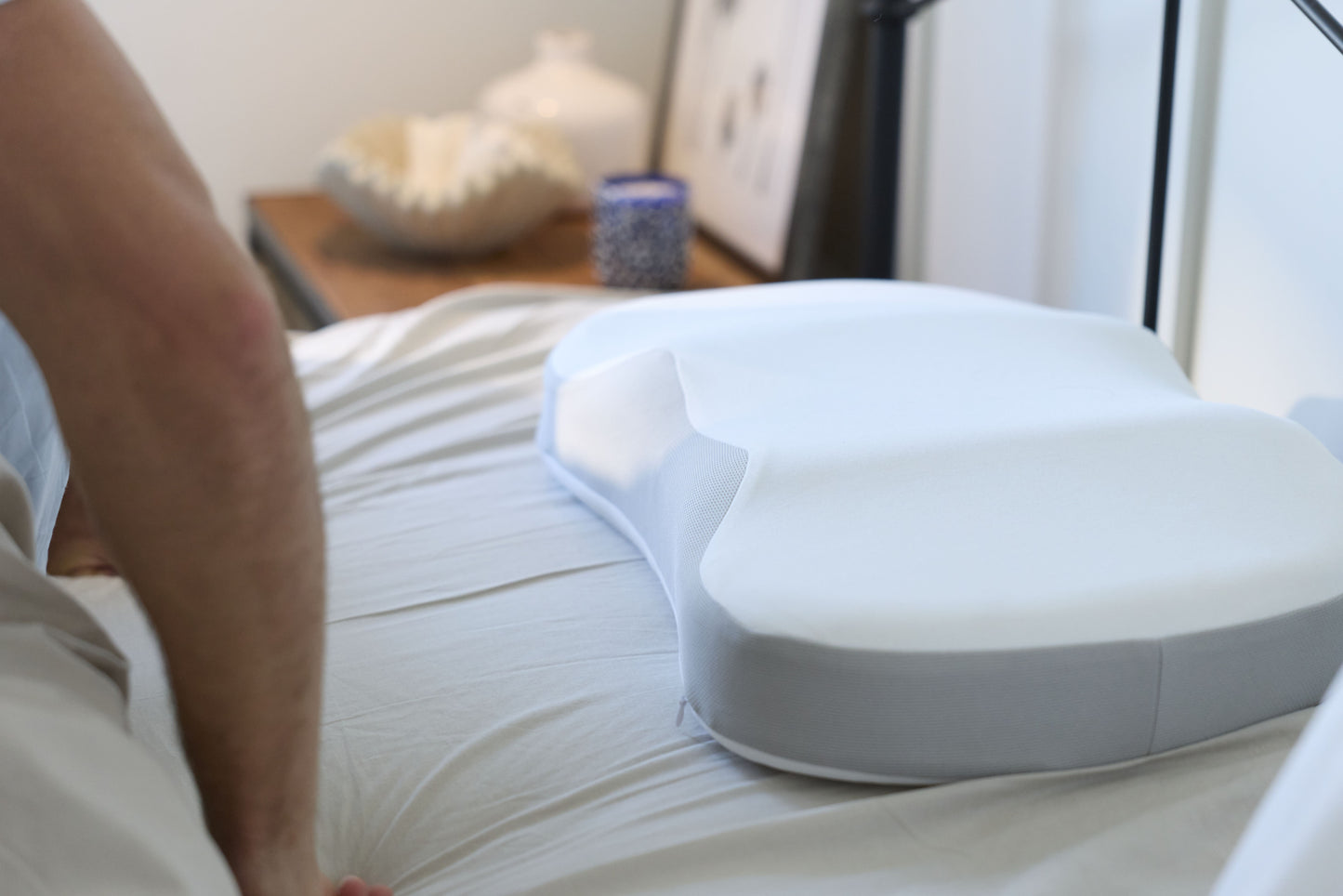 A Multi-Position Neck Pillow on a mattress 