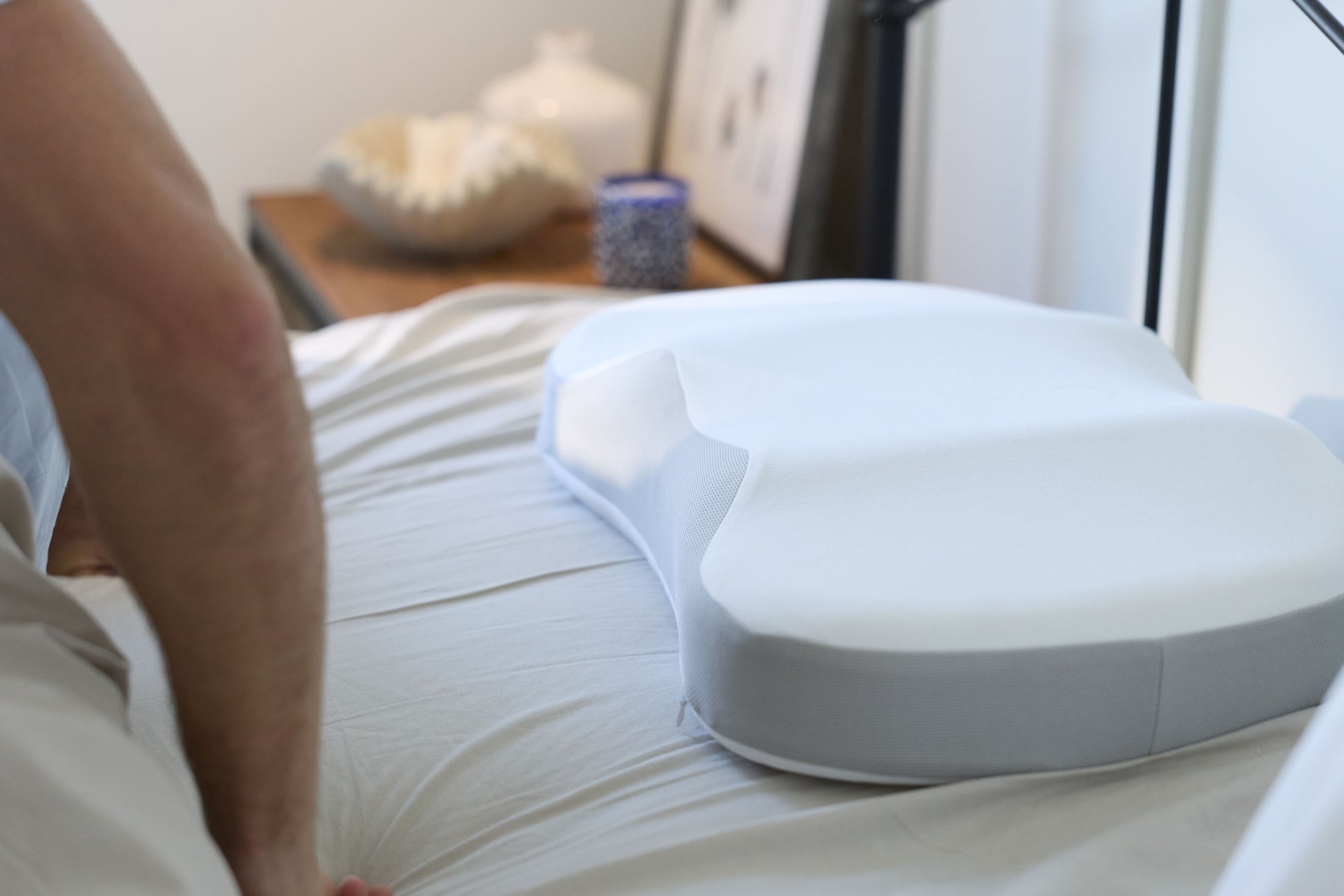 A Multi-Position Neck Pillow on a mattress 