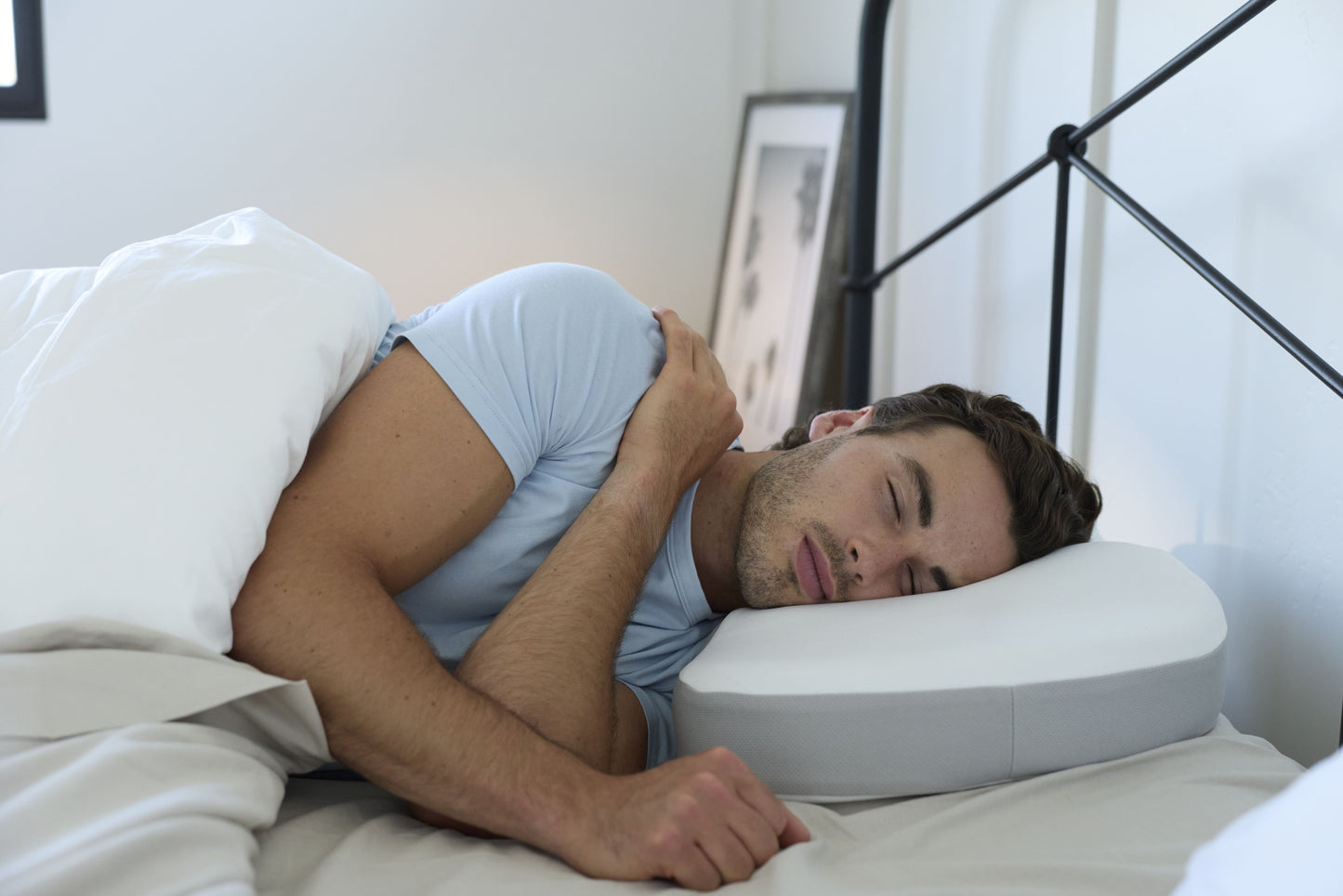 A man sleeping using the Multi-Position Neck Pillow