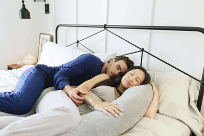 Couple lying in bed with the Pregnancy Body Pillow